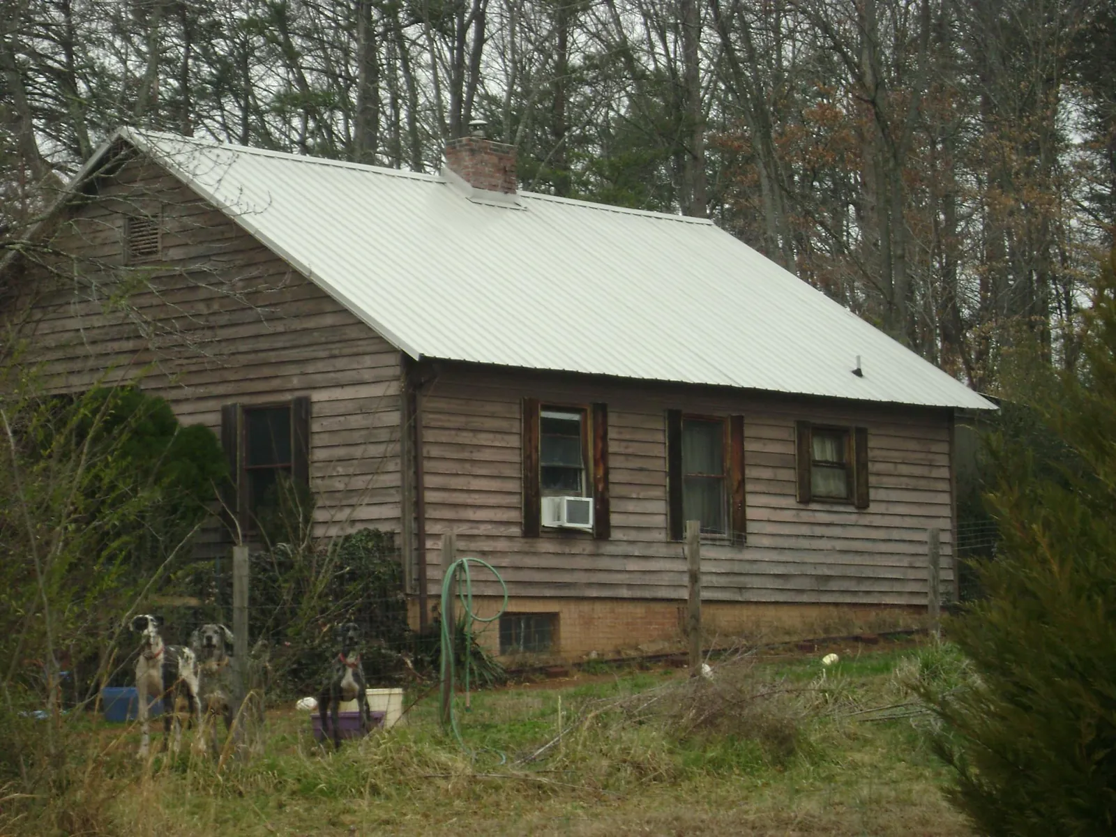 White metal roof on an old wood sided farmhouse, from a Metal Roof Installation job in Menno